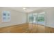 Bedroom with hardwood floors, a sliding door to the balcony and a window at 5242 Manorwood Dr Dr # 3A, Sarasota, FL 34235