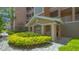 Building entrance featuring manicured landscaping and a covered entry with columns at 5242 Manorwood Dr Dr # 3A, Sarasota, FL 34235