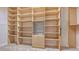 Spacious walk-in closet with custom built-in shelving provides ample storage space for organization at 5242 Manorwood Dr Dr # 3A, Sarasota, FL 34235