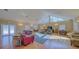 Clubhouse interior featuring hardwood floors, comfortable seating areas, a large window, and TV at 5242 Manorwood Dr Dr # 3A, Sarasota, FL 34235