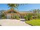 Clubhouse exterior with well-maintained landscaping, brick driveway, and large windows at 5242 Manorwood Dr Dr # 3A, Sarasota, FL 34235