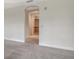 Hallway leading to bathroom, featuring neutral carpeting and soft lighting at 5242 Manorwood Dr Dr # 3A, Sarasota, FL 34235