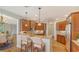 Open kitchen with granite countertops, wood cabinetry, and breakfast bar seating at 5242 Manorwood Dr Dr # 3A, Sarasota, FL 34235