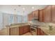 Well-equipped kitchen with stainless steel appliances, granite counters and custom backsplash at 5242 Manorwood Dr Dr # 3A, Sarasota, FL 34235