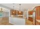 Open kitchen featuring granite countertops, wood cabinetry, and seating at the breakfast bar at 5242 Manorwood Dr Dr # 3A, Sarasota, FL 34235