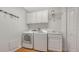 Clean and organized laundry room features modern appliances, white cabinetry, and a sink at 5242 Manorwood Dr Dr # 3A, Sarasota, FL 34235
