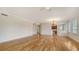 Open concept living area with hardwood floors and views of the kitchen and dining area at 5242 Manorwood Dr Dr # 3A, Sarasota, FL 34235