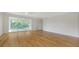 Bright, spacious living room with beautiful floors and sliding glass doors to the balcony at 5242 Manorwood Dr Dr # 3A, Sarasota, FL 34235