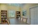 Meeting room with a large table, chairs, bookshelves, and natural light from a window at 5242 Manorwood Dr Dr # 3A, Sarasota, FL 34235