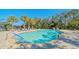 Resort-style community pool surrounded by palm trees and lounge chairs for residents to enjoy at 5242 Manorwood Dr Dr # 3A, Sarasota, FL 34235