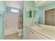 This bathroom offers a tub/shower combo and bright lighting at 5601 Bentgrass Dr # 10-105, Sarasota, FL 34235