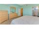 This bedroom features an ensuite bathroom, light-blue walls and carpet at 5601 Bentgrass Dr # 10-105, Sarasota, FL 34235