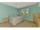 Serene bedroom featuring a comfortable bed, stylish dressers, and a bright window at 5601 Bentgrass Dr # 10-105, Sarasota, FL 34235