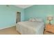 Comfortable bedroom features light-blue walls and neutral-toned carpet at 5601 Bentgrass Dr # 10-105, Sarasota, FL 34235