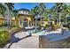 Beautiful clubhouse with a charming fountain surrounded by lush landscaping and palm trees at 5601 Bentgrass Dr # 10-105, Sarasota, FL 34235