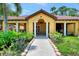 Inviting clubhouse exterior with well-maintained landscaping and covered seating areas at 5601 Bentgrass Dr # 10-105, Sarasota, FL 34235