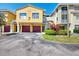 Bright two-story townhome with individual garages, well-maintained landscaping, and an inviting entrance at 5601 Bentgrass Dr # 10-105, Sarasota, FL 34235