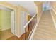 Hallway with carpeted stairs leading to a bathroom and dining area at 5601 Bentgrass Dr # 10-105, Sarasota, FL 34235