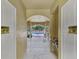 Hallway view of a pool featuring water fountains and caution signage on the entry doors for safety at 5601 Bentgrass Dr # 10-105, Sarasota, FL 34235