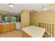 Bright kitchen with white appliances and light wood cabinets; open to the living and dining areas at 5601 Bentgrass Dr # 10-105, Sarasota, FL 34235