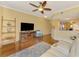 Bright living room with bar seating to the kitchen, complete with entertainment center and ceiling fan at 5601 Bentgrass Dr # 10-105, Sarasota, FL 34235