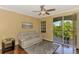 Relaxing living room with a modern sofa, stylish rug, and access to the outdoor balcony at 5601 Bentgrass Dr # 10-105, Sarasota, FL 34235