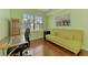 Bright office featuring a desk, a comfortable sofa, and a large window offering serene outdoor views at 5601 Bentgrass Dr # 10-105, Sarasota, FL 34235