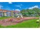 Community playground featuring slides, swings, and climbing structures with colorful townhomes in the background at 5601 Bentgrass Dr # 10-105, Sarasota, FL 34235