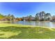 Scenic community pond with a fountain feature, surrounded by lush greenery and mature trees at 5601 Bentgrass Dr # 10-105, Sarasota, FL 34235