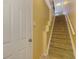Carpeted stairs with white risers and yellow walls, leading to the upper level of the townhome at 5601 Bentgrass Dr # 10-105, Sarasota, FL 34235