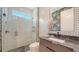 Bathroom with a glass-enclosed shower and a vanity area with a designer mirror and fixtures at 5793 Long Shore Loop, Sarasota, FL 34238