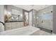 Modern bathroom with a soaking tub, walk-in shower, and stylish tile work at 5793 Long Shore Loop, Sarasota, FL 34238