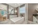 Luxurious bathroom featuring a soaking tub, elegant fixtures, and modern design at 5793 Long Shore Loop, Sarasota, FL 34238