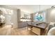 Elegant dining room with hardwood floors, designer light fixture and modern built-in storage at 5793 Long Shore Loop, Sarasota, FL 34238