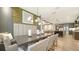 Open-concept dining area featuring hardwood floors, stylish lighting, and easy access to living room and kitchen at 5793 Long Shore Loop, Sarasota, FL 34238