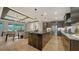 Modern kitchen featuring a large island, stainless steel appliances, and an open-concept design at 5793 Long Shore Loop, Sarasota, FL 34238