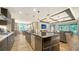 Open concept kitchen and living room featuring an island, stainless steel appliances and hardwood floors at 5793 Long Shore Loop, Sarasota, FL 34238