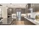 Modern kitchen featuring an island, stainless steel appliances, stylish countertops and a gas range at 5793 Long Shore Loop, Sarasota, FL 34238