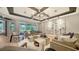 Open concept living room features hardwood floors, stylish furnishings and access to the outdoor space at 5793 Long Shore Loop, Sarasota, FL 34238