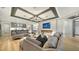 Modern living room featuring hardwood floors, recessed lighting, modern fireplace, and stylish furniture at 5793 Long Shore Loop, Sarasota, FL 34238