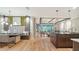 Open-concept living area with hardwood floors, modern lighting, and dining space at 5793 Long Shore Loop, Sarasota, FL 34238