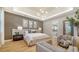 Luxurious main bedroom suite with elegant lighting, wall decor, and sitting area at 5793 Long Shore Loop, Sarasota, FL 34238