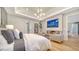 Comfortable main bedroom with a cozy fireplace, TV, and stylish decor at 5793 Long Shore Loop, Sarasota, FL 34238