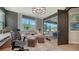 Well-lit home office with a comfortable couch and a modern desk area by a large window at 5793 Long Shore Loop, Sarasota, FL 34238