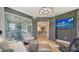 Stylish home office with modern furniture, patterned wallpaper, and access to an outdoor living space at 5793 Long Shore Loop, Sarasota, FL 34238