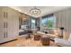 Bright home office with custom cabinetry, a comfortable seating area, and natural light at 5793 Long Shore Loop, Sarasota, FL 34238