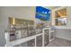 Close-up of a stainless steel grill and outdoor kitchen setup, with a flatscreen TV nearby at 5793 Long Shore Loop, Sarasota, FL 34238