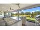Spacious screened-in patio with an outdoor kitchen overlooking a tranquil pond at 5793 Long Shore Loop, Sarasota, FL 34238