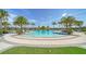 Enjoy the Florida sunshine at the community pool surrounded by lush landscaping and comfortable lounge chairs at 5793 Long Shore Loop, Sarasota, FL 34238