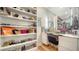 Spacious walk-in closet with custom shelving, drawers, and a vanity area at 5793 Long Shore Loop, Sarasota, FL 34238